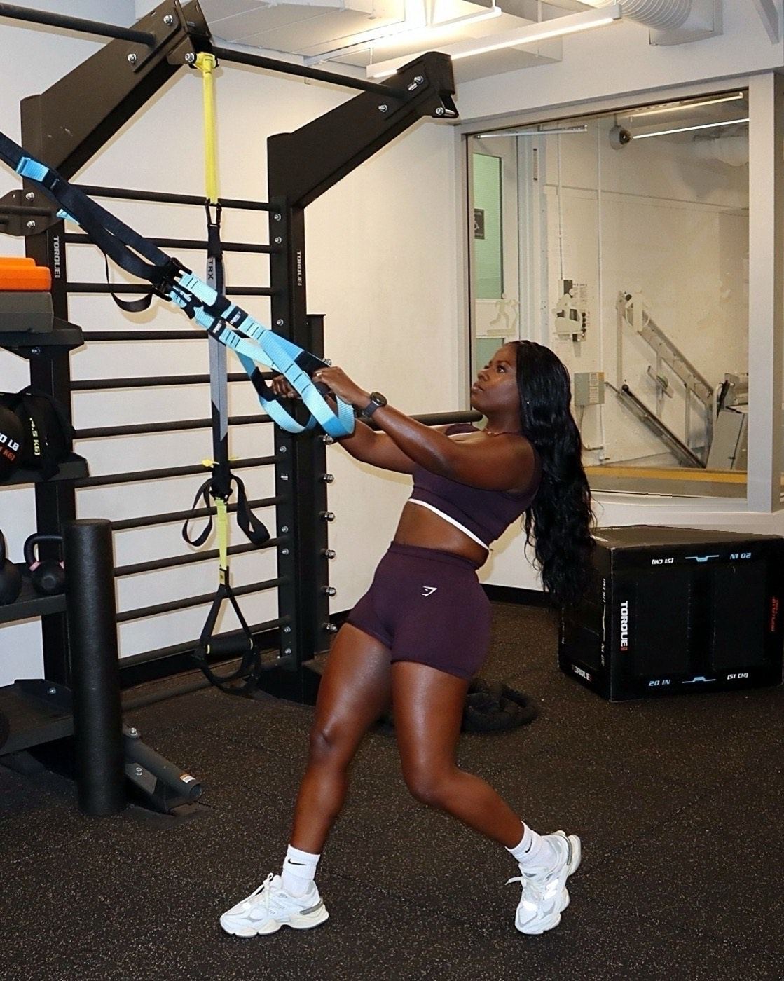 Temi mid-row on the TRX straps in a Vancouver gym